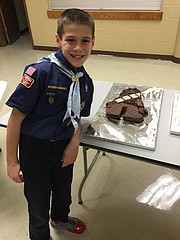 Joshua Mackiewicz, 8, stands in front of his Chewbacca cake, which took home the prize for best Star Wars cake.