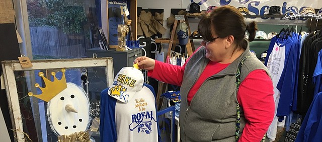 Angie Bensouda takes a peek at some merchandise at ShananiGanns, 12208 Johnson Drive.