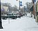 A downtown business owner shovels snow from the sidewalk on Eighth Street ...
