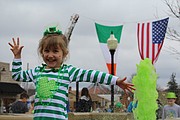 Jillian Stephen, 4, poses in front of the fountain at City Hall in downtown Shawnee during the St. Patrick's Parade.