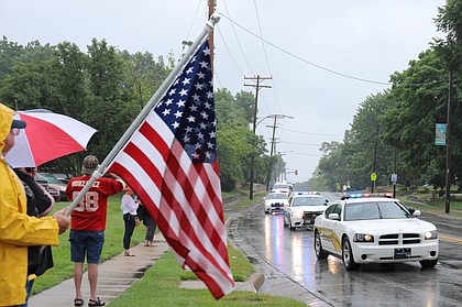 People line the streets of Shawnee to pay their respects to two fallen officers during a funeral procession last Thursday.