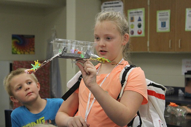 Aspiring astronaut Abigail Snell, 12, shows off her latest project at Camp Invention at Good Shepherd Catholic School in Shawnee. The soon-to-be seventh-grader has participated in the popular summer camp since she was in first grade.