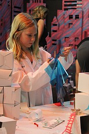 Nine-year-old Abby Schmitz, of Shawnee, works on her mini mansion at Camp Invention on July 10.