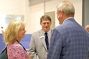 Shawnee Mission school board member Patty Mach, who represents the SM Northwest area, and her husband share a laugh with Fulton at the open house.