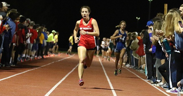 Shawnee Mission North senior Katie Kasunic approaches the finish line at the Olathe Twilight Meet on Saturday at the Olathe District Activity Center. Kasunic finished second with a time of 19:09.1.
