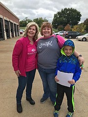 Shawnee Christian Brothers Automotive co-owner Tammie Green, left, poses for a photo with Ginger Elliott and her son.