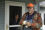 Dennis Ruhnke holds two of his remaining N-95 masks as he stands with his wife, Sharon at their home near Troy Friday, April 24, 2020. Dennis, a retired farmer, shipped one of the couple’s five masks left over from his farming days to New York Gov. Andrew Cuomo for use by a doctor or a nurse. (AP Photo/Charlie Riedel)