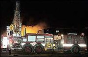 Firefighters battle a blaze at Popp's Restaurant Sunday night. The
fire, reported about 6:30 p.m., destroyed the restaurant, which was
closed for the day and unoccupied. The State Fire Marshal
investigated the fire Monday and determined the cause the be the
restaurant's heating system. Baldwin City Fire Chief Allen Craig
said the department's ladder truck helped save the fire from
spreading to neighboring mobile homes.