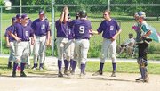 It was high fives all around for Jason Rose (No. 9) after he
powered a home run to get the Baldwin Legion on the scoreboard
during Sunday's game.