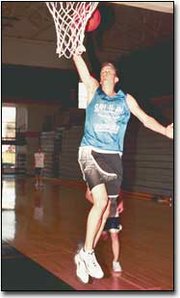 The winter sports season got under way Monday when high school
teams in the state could officially start practices.
Basehor-Linwood senior Mike Horn participated in a layup drill
during the Bobcats` first practice. The season will tip off on Dec.
1 when the Bobcats play host to Bonner Springs.