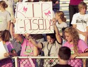 De Soto High School students Kelsy Fisher, Jordin Burford and Laura
Lambert pay their respects to Griselda Del Real with a moment of
silence before the start of the school's football game Friday
against Sumner Academy. Money was collected at the game to help her
family with hospital and funeral expenses. Scott Schliecher,
manager of the De Soto Taco Bell/KFC where Del Real worked, said he
expected about $4,500 to be collected when efforts ended Wednesday
at the restaurant, the high school and other outlets in De Soto.