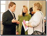 New Oz Entertainment CEO Dick Ferguson talks with Kristin McCallum
and Carol Farmer following his introduction at the DeSoto Chamber
of Commerce meeting Thursday. Ferguson promised to bring the theme
park proposal back before the county commission.