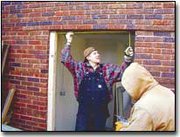 Chad Cairer, left, and Geoff Barker of CPM Corporation, take
measurments on the door leading to the wheelchair ramp at the new
City Hall.