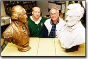 DeSoto High art teacher Tim Mispagel and Darrel Zimmerman strike
their best Mt. Rushmore poses between the well-travelled busts of
George Washington and Abraham Lincoln. Zimmerman hopes to return
the busts to their original home.