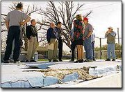 City officials and current and future De Soto City Council members
discuss the repairs needed at the city pool during a special
meeting last Thursday. De Soto Parks and Recreation Director Jay
Garvin discovered large chunks of the pool's deck had deteriorated
over the winter. The repairs will again be addressed at the regular
city council meeting Thursday.