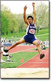 Mill Valley senior Dominique Burgin tries to control his landing in
the long jump at the KU Relays. Burgin took third place in the
event and set a school record in Friday's competition.