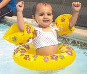 Avery Oetting, 19 months, enjoys a day at the pool with her parents
Greg and Crystal Oetting. The Eudora Municipal Pool opened for the
season Saturday and has been busy ever since.