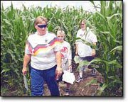 Visiting from Lawrence, Kathy Cobb, Michael Torneden, 9, and Wendy
Reed make their way through the rows of corn that form the
butterfly maze. Owner John Pendelton hopes attendance to the maze
will top 10,000 this year.