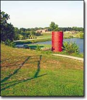 The 18th hole at Oak Country Golf Course is a mere 115 yards to the
pin, but the island green and elevated tee box makes for a golf
challenge that requires both a good touch and accuracy with a short
iron.