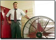 This time of year, the building problems at Eudora Middle School
are more than just a lot of hot air. Principal Dale Sample shows
one of the many fans used to cool a building that has no air
conditioning. As a result, the doors remain open, which creates a
student-safety issue.