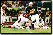 Paola junior running back Jordan Savy slips past a couple of
Cardinal defenders before being caught by senior defensive back
John Powers. The Cardinals won for the first time ever against
Paola, 14-13, in overtime.