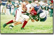 Sophomore Kaleb Niedens is pulled to the ground by a Louisburg
defender during a 28-0 defeat. Penalties, turnovers and strong
defensive play by the Wildcats shut down the Cardinal offense last
Friday night.
