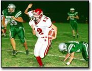 Sophomore running back Andrew Pyle looks for an opening as he runs
the ball into the end zone for a fourth quarter score.