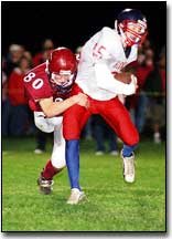Junior defensive back Cody Lauber takes down Hiawatha senior
running back Eli Korthanke. The Cardinal defense wasnt able to
contain the Redskins running game on big plays throughout the game.