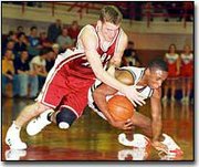 Eudora senior Matt Fisher reaches over Lansing sophomore Hosea
Morgan for a loose ball. Fisher paced the Cardinals with a
team-high 20 points.