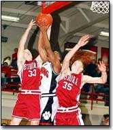 Eudora junior Tommy Shutt and senior Wes Hinman compete with
Lansing sophomore Hosea Morgan during the last minutes of the
Cardinal's 54-50 victory in the Tonganoxie invitational tournament.
