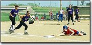 Eudora senior Shena Niedens makes it back to base safely during the
Cardinal's first game against the Baldwin Bulldogs. Baldwin took
both games of the series 7-3 and 8-1.