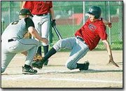 Eudora High freshman Brandon Werst unsuccessfully tries to avoid a
tag as he slides into home during the Cardinal's loss to Paola.
Next up, Eudora travels Osawatomie this afternoon.