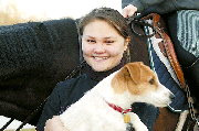 Alice Howey, who has trained Sara Shockey to jump, holds Wilbur,
her dog that accompanies her and Sara to competitions.