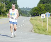 Al Pursell, Leavenworth, heads east on Evans Road during the
library's run. Pursell, who is 75, was the oldest runner to
participate in the 10K.