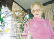 Lela Morley gazes down at her pet parakeet Sunshine. She and her
husband have owned birds since before moving to Eudora 35 years
ago.