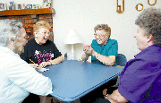 Edna Sullivan, second from right, grins as she shakes the dice
during Thursday afternoon's bunco party at the rural McLouth home
of Margie McQuitty. Also pictured, from left, are, Mary Seufert,
Tonganoxie, and Charlotte Robinson and Charlene Wagner, both of
McLouth. The bunco group has continued, with various members, since
the early 1980s.