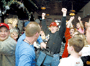 Casey Boatwright, center, and others who watched the season finale
of Survivor at Bichelmeyer's Steakhouse in Tonganoxie, cheer as his
sister, Danni Boatwright is named winner of Survivor.