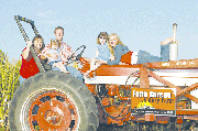 Mike and Angela Oelschlaeger continue his family's tradition of
living on the farm northwest of Linwood, and farming the land. With
them are their three daughters, from left, McKinna, Sydnee and Tia.