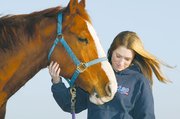 Courtenay DeHoff has been riding horses for as long as she can
remember. The 15-year-old Tonganoxie teen plans a career as a
professional rodeo rider. She and one of her quarter horses, Nick,
share a quiet moment.