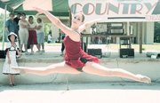 This dancer performs a midair feat as onlookers watched from the
stage during Saturday morning's festivities at VFW Memorial Park.
Dancers in Brenda Graves dance group performed at Tonganoxie Days.
Throughout the park, dozens of cars were displayed at the Country
Cruisers Car Show.