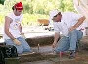 Kansas State University anthropology professor Brad Logan sifts
through dirt in an area of a prehistoric house near Tonganoxie.
With Logan is student Clint Stueve.