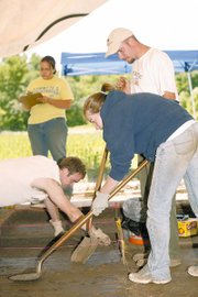 K-State anthropology students tediously carry out a dig at an area
near Tonganoxie. Students pictured counter-clockwise from front are
Michelle Wettig, Toby Blake, Lindsey Riners and Trever Murawski.