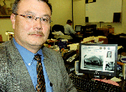 When he was a child, Dana Gouge knew he wanted to be a police
officer. His goal took him not only into law enforcement, but also
into homicide investigations, where he worked with a team that this
year snagged Wichita's BTK serial killer. On the computer screen
behind Gouge is a photo of the home of Shirley Vian, a BTK victim.