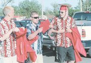 Tonganoxie High School seniors Chris Mullins, left, Steve Adcox and
Chad Vukas, arrived early to prepare for Saturday's graduation
ceremony held at Beatty Field.