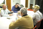 Wednesday mornings at Tonganoxie Historical Site include time for a
coffee break, with cookies. Talking over the events of the day are,
from left clockwise, George Cooper, Gene Ward, Bill Latham and Del
Englen.