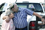 Margarete and Marvin Harrison share a hug after watching the
landing of Virgin Atlantic GlobalFlyer.