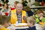 Casey Jones, one of the oldest members of Linwood Lions Club,
enjoys lunch at school with the children.
