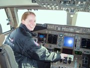 Nancy Milleret sits in the captain's seat of the Boeing 747-400
that brought the British media and Richard Branson into Salina.