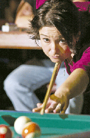Nicolette Ducey, Bonner Springs, readies to make her shot last week
during a game at Side Pockets in Bonner Springs. Ducey, and three
other women on the team, "4 Squaws," play pool together every
Tuesday and Wednesday night. The women compete at tournaments in
the Kansas City area and Topeka. And once a year, they compete at
an international competition in Las Vegas.