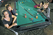 There may be fewer women than men who are serious pool players in
competitive leagues. Yet these women, who play pool together, who
cheer each other on, and who continue to rack up the points, are
confident and comfortable at the pool tables. Pictured clockwise
from lower left are, Keleigh Scheuermann, Lin Davis, Nicolette
Ducey and Terry Mitchener. The women also have careers and
interests outside the pool hall. Scheuermann makes pottery, Davis
is an analyst for Sprint Nextel, Ducey works at an Olathe dental
lab where she's immersed in the intracacies of making crowns and
bridges, and Terry works for Holliday Sand and Gravel in Bonner
Springs.